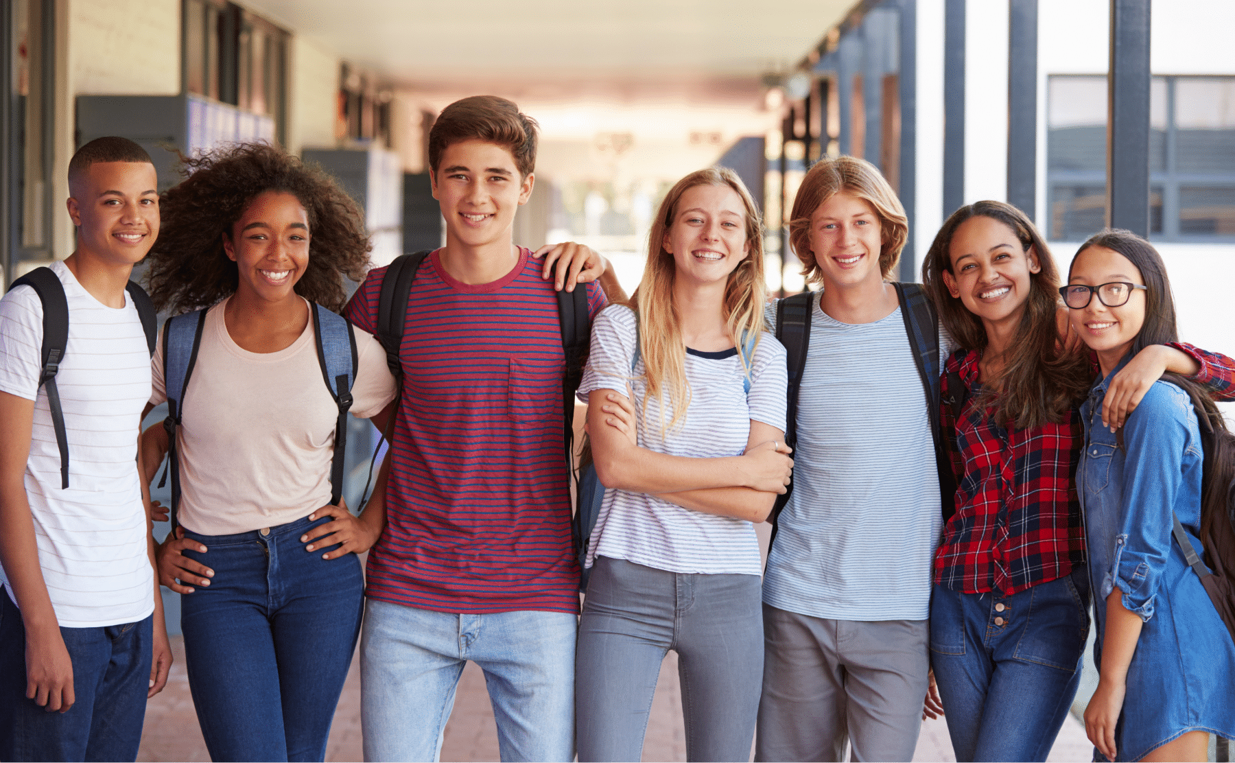 teenage-classmates-standing-in-high-school-hallway-PNJYD5L 1